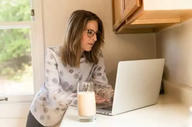 woman with glass of almond milk